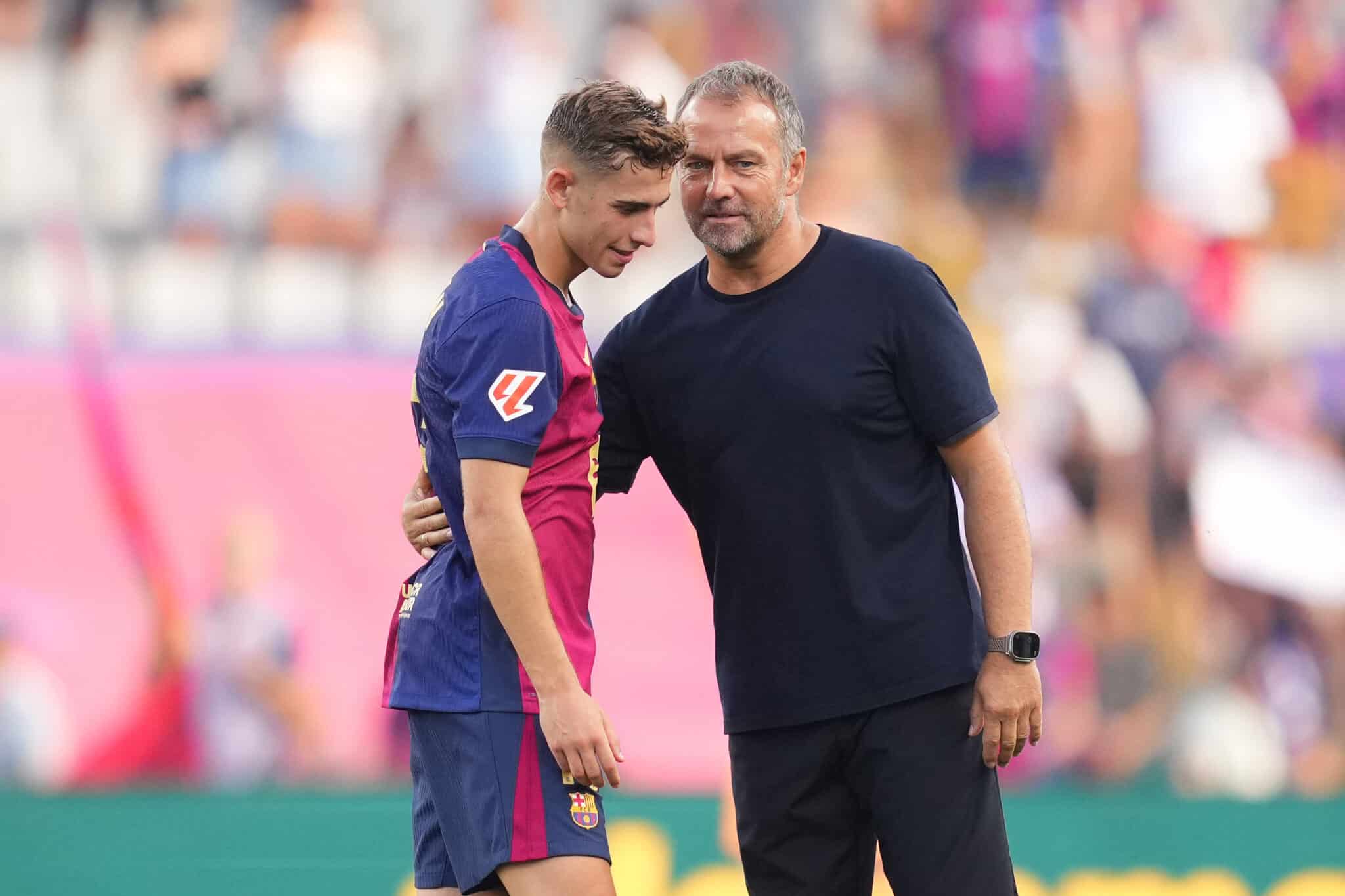 Hansi Flick, Head Coach of FC Barcelona, interacts with Fermin Lopez of FC Barcelona following the La Liga match.