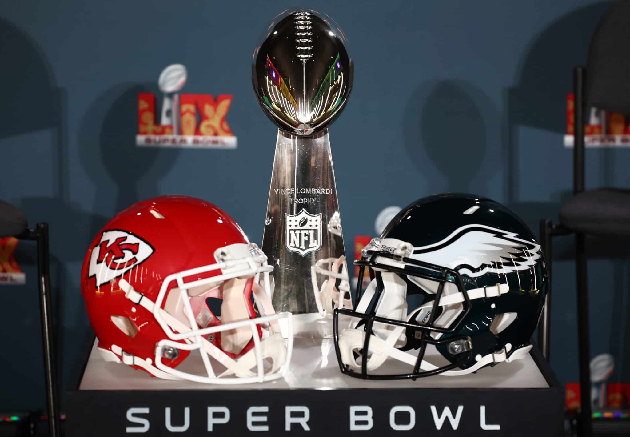 NEW ORLEANS, LOUISIANA - FEBRUARY 03: A Kansas City Chiefs helmet, the Vince Lombardi Trophy and a Philadelphia Eagles helmet are seen before the NFL Commissioner Roger Goodell's Super Bowl Press Conference ahead of Super Bowl LIX