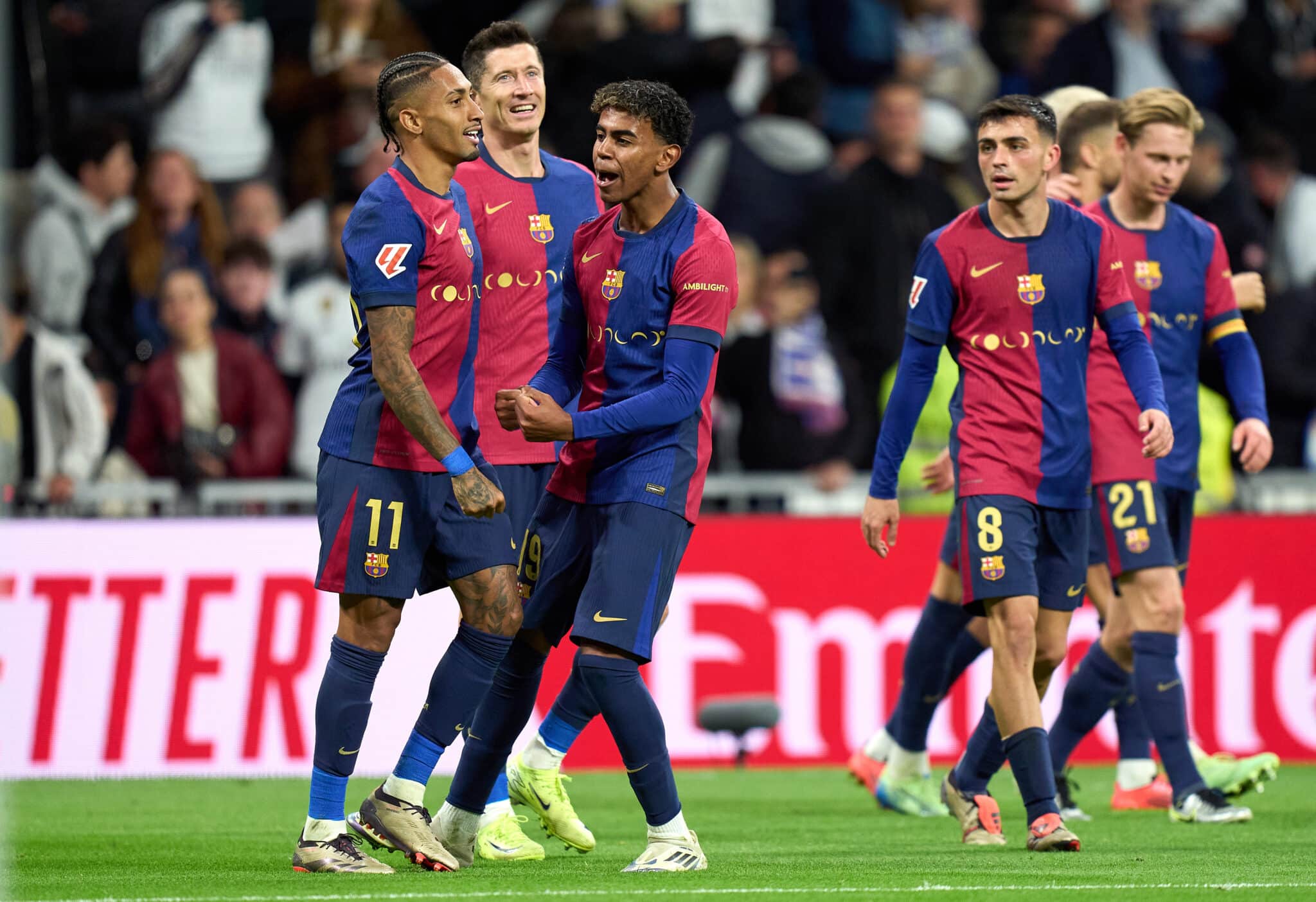 Raphinha of FC Barcelona celebrates scoring his team's fourth goal with teammates Robert Lewandowski and Lamine Yamal during the LaLiga match