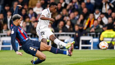 Vinicius Junior player of Real Madrid kicks the ball as Ronald Araujo of Barcelona slides during the Copa Del Rey Semi Final