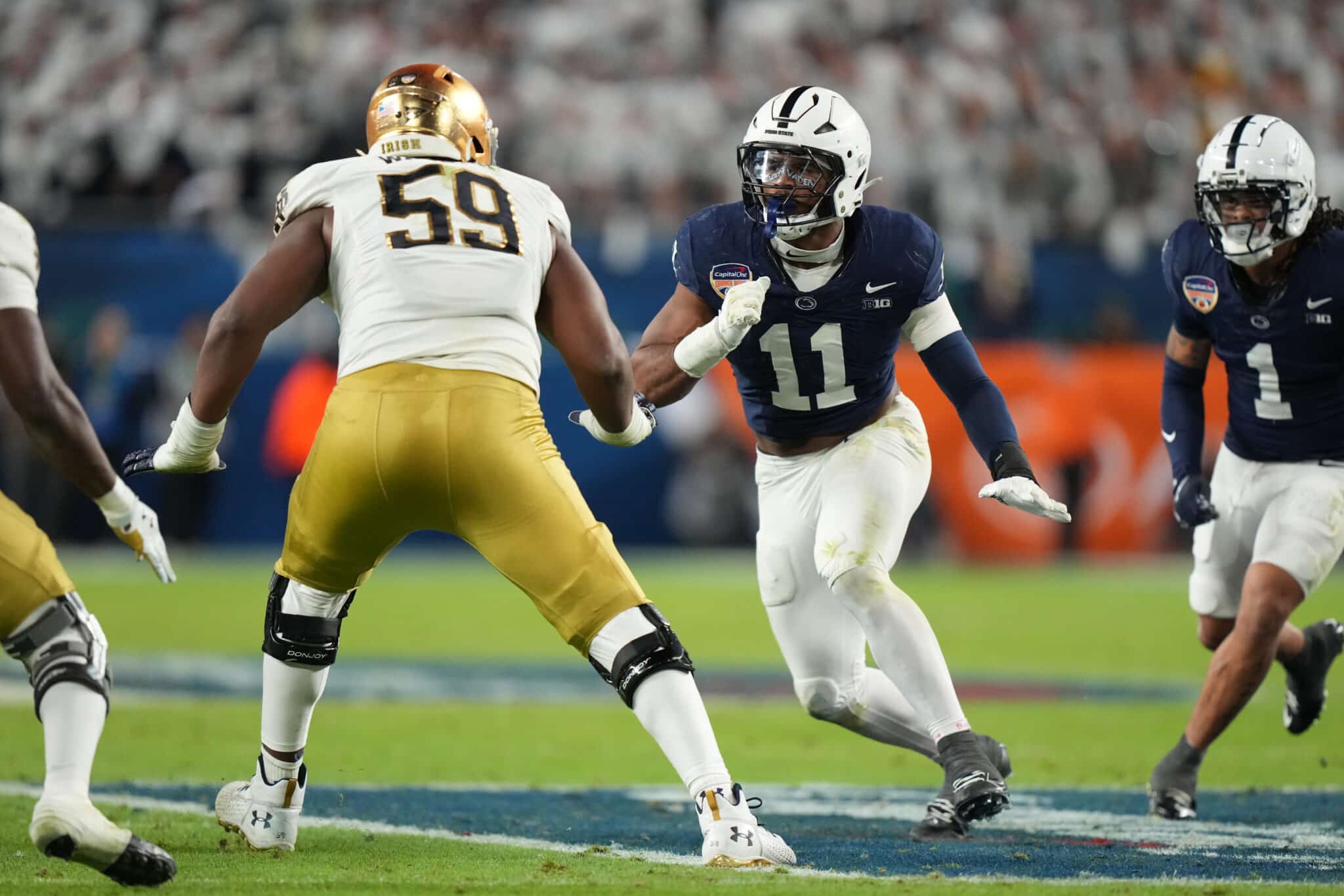 MIAMI GARDENS, FL - JANUARY 09: Penn State Nittany Lions defensive end Abdul Carter (11) rushes the passer during the Penn State Nittany Lions versus Notre Dame Fighting Irish College Football Playoff Semifinal at the Capital One Orange Bowl on January 9, 2025, at Hard Rock Stadium in Miami Gardens, FL.