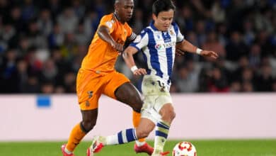 Vinicius Junior of Real Madrid battles for possession with Takefusa Kubo of Real Sociedad during the Copa del Rey Semi Final match