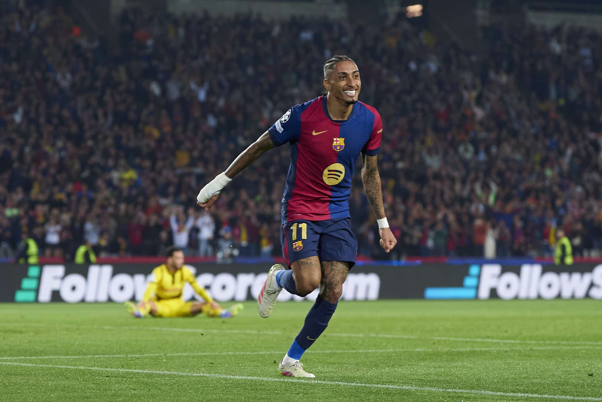 Raphinha of FC Barcelona celebrates his team's fourth goal scored by Lamine Yamal during the UEFA Champions League 2024/25 Quarter Final First Leg match between FC Barcelona and Borussia Dortmund