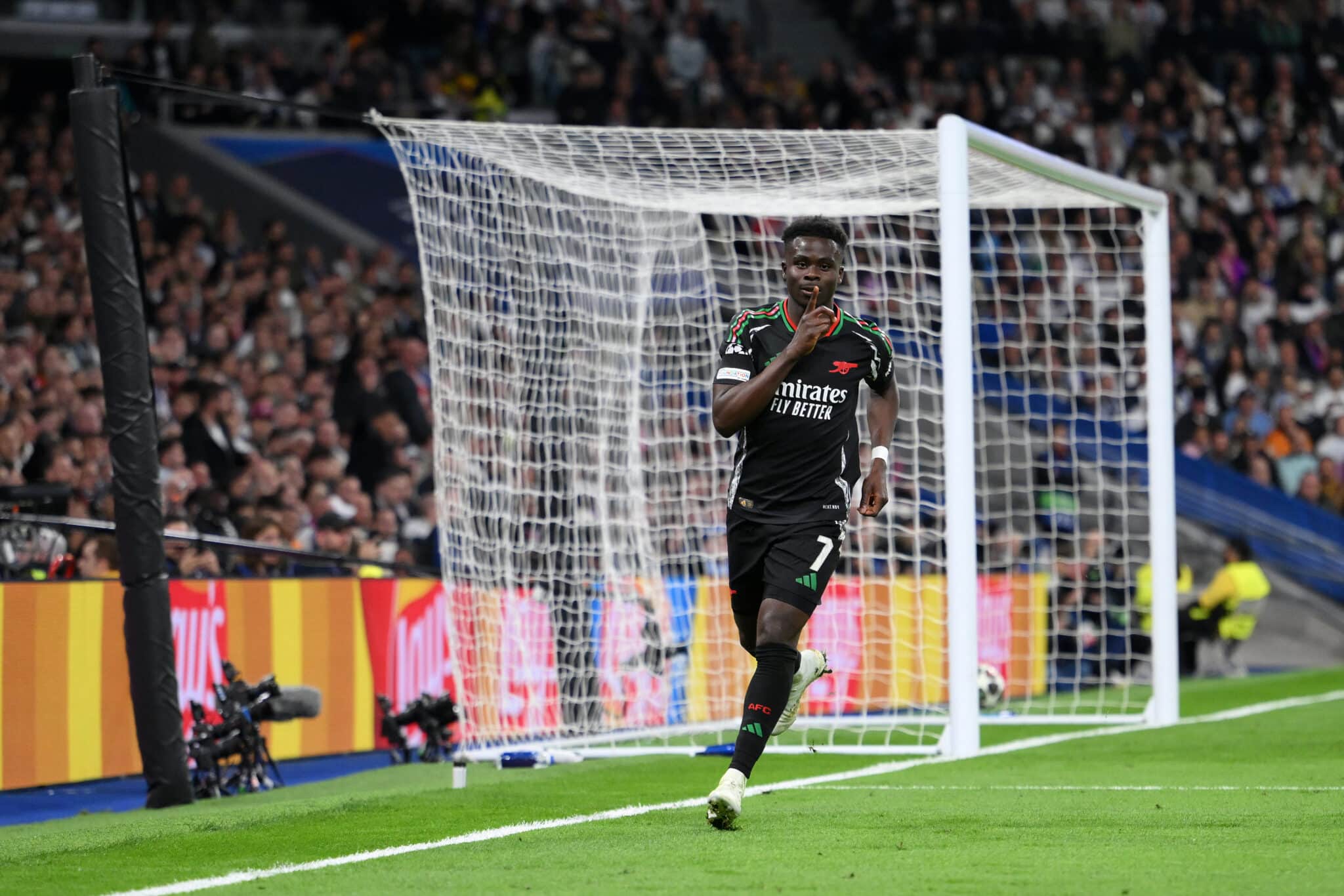 MADRID, SPAIN - APRIL 16: Bukayo Saka of Arsenal celebrates scoring his team's first goal during the UEFA Champions League 2024/25 Quarter Final Second Leg match between Real Madrid C.F. and Arsenal FC at Estadio Santiago Bernabeu on April 16, 2025 in Madrid, Spain.