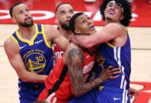 Golden State Warriors' Gui Santos and Houston Rockets'Jabari Smith, Jr. vie for rebound position in 2nd quarter during Game 1 of First Round of NBA Playoffs at Toyota Center in Houston, Texas on Sunday, April 20, 2025.