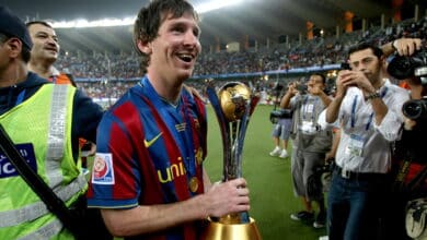 Barcelona's Lionel Messi holds the 2009 FIFA Club World Cup trophy as he celebrates the Spanish club's victory at Zayed Sports City Stadium in Abu Dhabi on December 19, 2009. Barcelona beat Argentina's Estudiantes de La Plata 2-1 in the final football match. AFP PHOTO/MARWAN NAAMANI