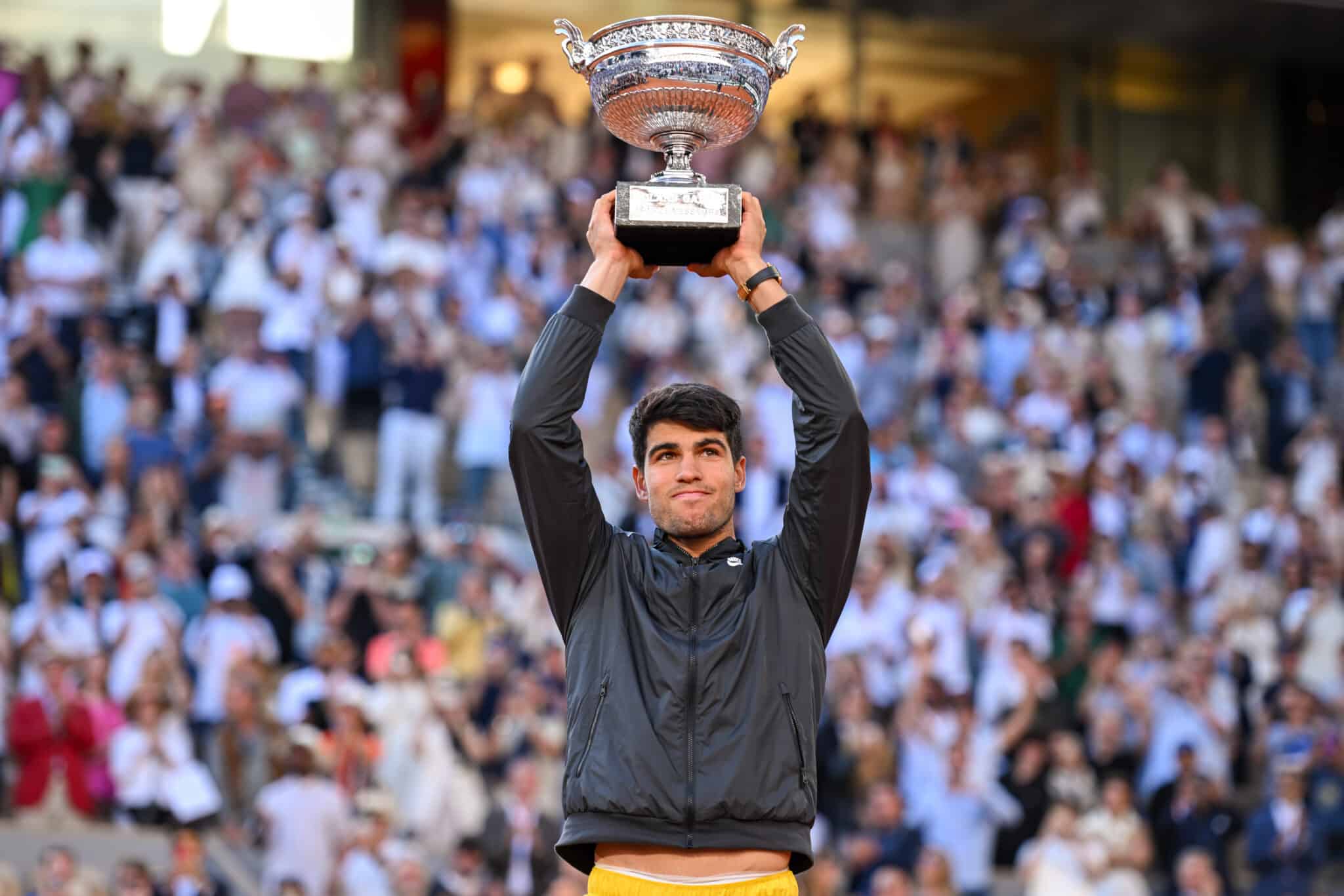 Carlos Alcaraz of Spain celebrates with the winners trophy after victory against Alexander Zverev