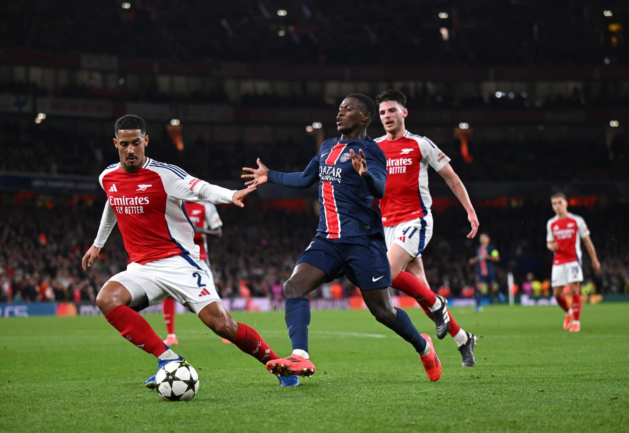 Nuno Mendes of Paris Saint-Germain is challenged by William Saliba of Arsenal during the UEFA Champions League 2024/25 League Phase MD2 match between Arsenal FC and Paris Saint-Germain Emirates Stadium at on October 01, 2024 in London, England.