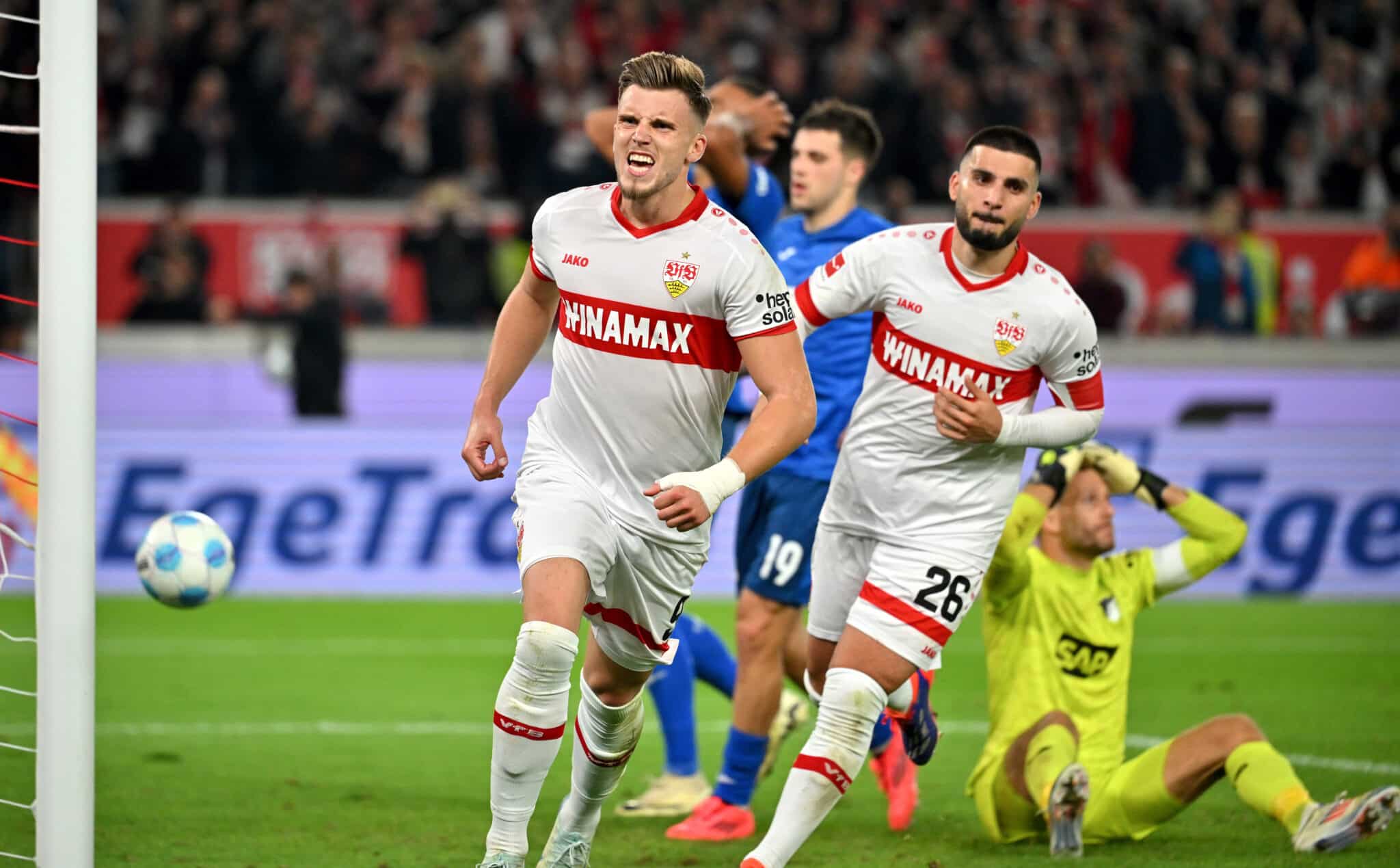 The Stuttgart players with scorer Ermedin Demirovic and Deniz Undav celebrate the 1:1 goal in stoppage time together, with beaten Hoffenheim.
