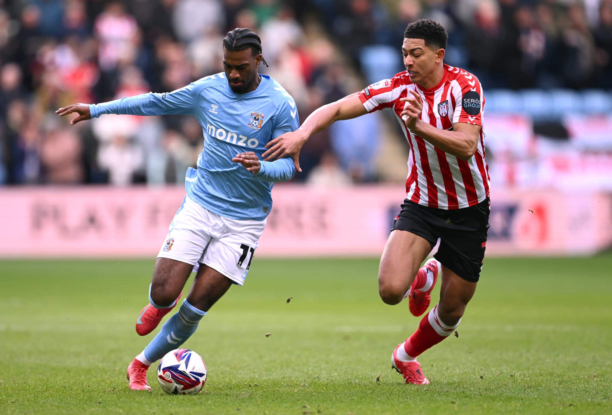 Haji Wright of Coventry City holds off the challenge of Jobe Bellingham of Sunderland