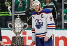 DALLAS, TX - MAY 29: Edmonton Oilers center Connor McDavid (97) accepts the Clarence S. Campbell Trophy after game 5 of the Western Conference Final between the Dallas Stars and the Edmonton Oilers on May 29, 2025 at American Airlines Center in Dallas, Texas.