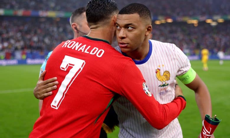 Kylian Mbappe of France embraces Cristiano Ronaldo of Portugal