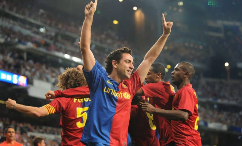 MADRID, SPAIN - MAY 02: Xavi Hernandez of Barcelona celebrates after Gerard Pique scored Barcelona's sixth goal during the La Liga match between Real Madrid and Barcelona at the Santiago Bernabeu stadium on May 2, 2009 in Madrid, Spain.
