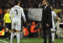 Real Madrid's Portuguese forward Cristiano Ronaldo (L) watches Barcelona's coach Josep Guardiola during the Spanish league "clasico" football match FC Barcelona vs Real Madrid at Camp Nou stadium on November 29, 2010 in Barcelona. Barcelona won 5-0. AFP PHOTO/ JAVIER SORIANO