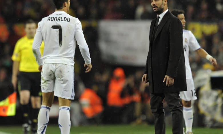 Real Madrid's Portuguese forward Cristiano Ronaldo (L) watches Barcelona's coach Josep Guardiola during the Spanish league "clasico" football match FC Barcelona vs Real Madrid at Camp Nou stadium on November 29, 2010 in Barcelona. Barcelona won 5-0. AFP PHOTO/ JAVIER SORIANO