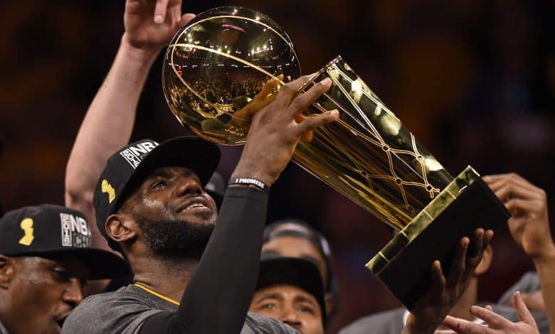 Cleveland Cavaliers' LeBron James (23) holds up the Larry O'Brien trophy after defeating the Golden State Warriors in Game 7 of the NBA Finals at Oracle Arena in Oakland, Calif., on Sunday, June 19, 2016. The Cleveland Cavaliers defeated the Golden State Warriors 93-89 to win the NBA championship.