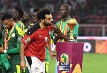 Egypt's forward Mohamed Salah walks past the trophy after losing the Africa Cup of Nations (AFCON) 2021 final