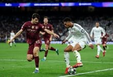 MADRID, SPAIN - FEBRUARY 19: Jude Bellingham of Real Madrid battles for possession with Abdukodir Khusanov of Manchester City during the UEFA Champions League 2024/25 League Knockout Play-off second leg match between Real Madrid C.F. and Manchester City at Santiago Bernabeu Stadium on February 19, 2025 in Madrid, Spain.