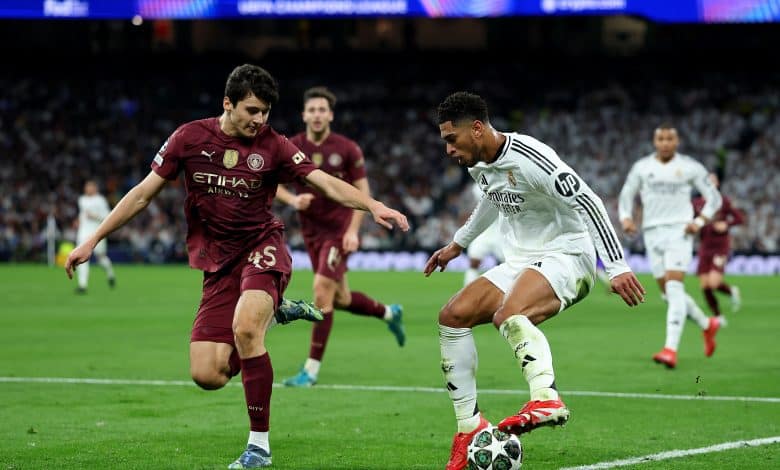MADRID, SPAIN - FEBRUARY 19: Jude Bellingham of Real Madrid battles for possession with Abdukodir Khusanov of Manchester City during the UEFA Champions League 2024/25 League Knockout Play-off second leg match between Real Madrid C.F. and Manchester City at Santiago Bernabeu Stadium on February 19, 2025 in Madrid, Spain.