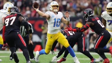 HOUSTON, TEXAS - JANUARY 11: Justin Herbert #10 of the Los Angeles Chargers passes against the Houston Texans during the AFC Wild Card Playoffs at NRG Stadium on January 11, 2025 in Houston, Texas.