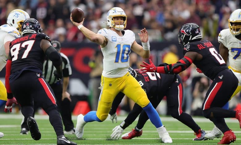 HOUSTON, TEXAS - JANUARY 11: Justin Herbert #10 of the Los Angeles Chargers passes against the Houston Texans during the AFC Wild Card Playoffs at NRG Stadium on January 11, 2025 in Houston, Texas.