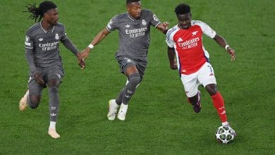 LONDON, ENGLAND - APRIL 08: Bukayo Saka of Arsenal runs with the ball under pressure from Eduardo Camavinga and David Alaba of Real Madrid during the UEFA Champions League 2024/25 Quarter Final First Leg match between Arsenal FC and Real Madrid C.F. at Arsenal Stadium on April 08, 2025 in London, England.