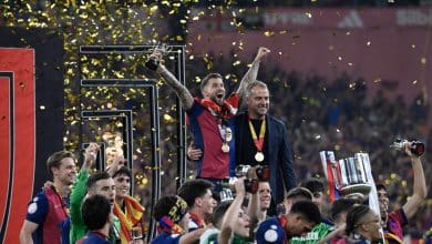 Barcelona's Spanish defender #05 Inigo Martinez Berridi (L) and Barcelona's German coach Hans-Dieter Flick (R) celebrate their victory with teammates after winning the Spanish Cup, Copa del Rey (King's Cup) final football match between FC Barcelona and Real Madrid CF at La Cartuja stadium in Seville on April 26, 2025.