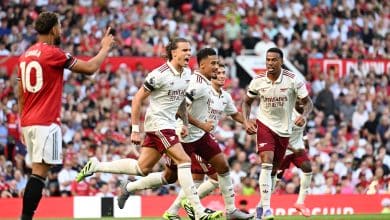 MANCHESTER, ENGLAND - AUGUST 17: Riccardo Calafiori of Arsenal celebrates scoring his team's first goal with William Saliba and Gabriel of Arsenal during the Premier League match between Manchester United and Arsenal at Old Trafford on August 17, 2025 in Manchester, England.