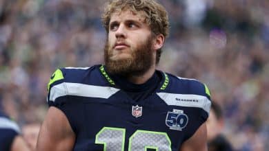 SEATTLE, WASHINGTON - JANUARY 25: Cooper Kupp #10 of the Seattle Seahawks stands on the sidelines during the national anthem prior to the NFC Championship NFL football game against the Los Angeles Rams at Lumen Field on January 25, 2026 in Seattle, Washington.